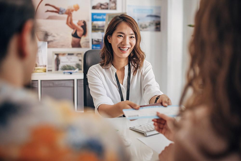 Travel consultant assisting a couple planning their destination wedding.