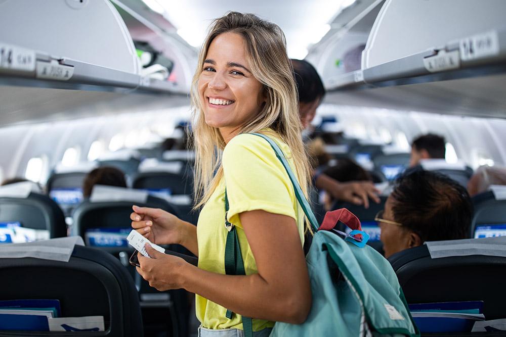 Woman happily boarding a plane