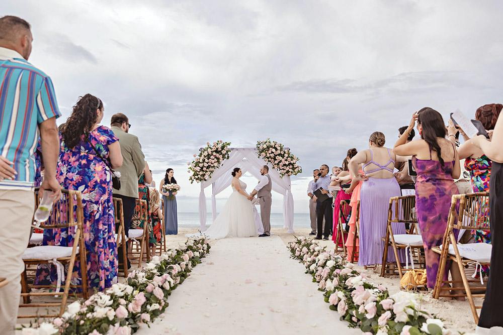 Bride and groom getting married at gorgeous beachfront wedding ceremony
