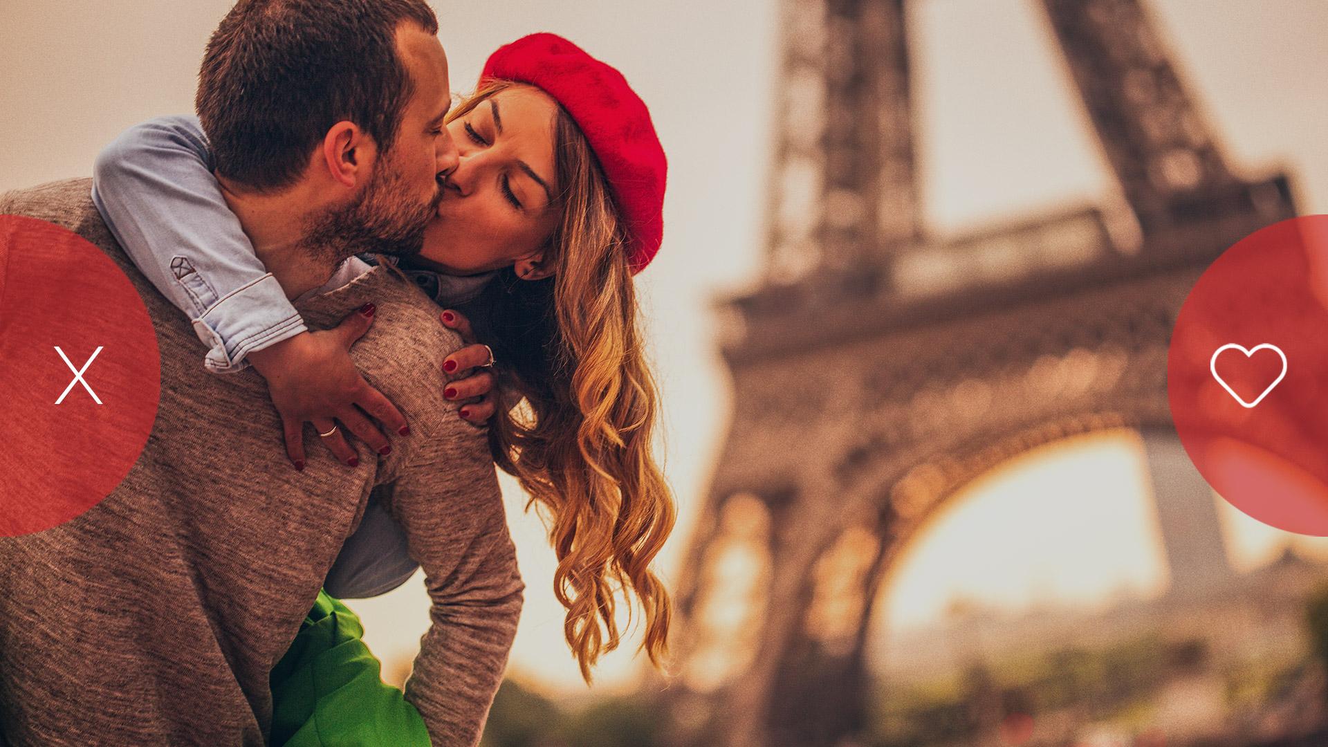 Couple sharing a kiss in front of the Eiffel Tower