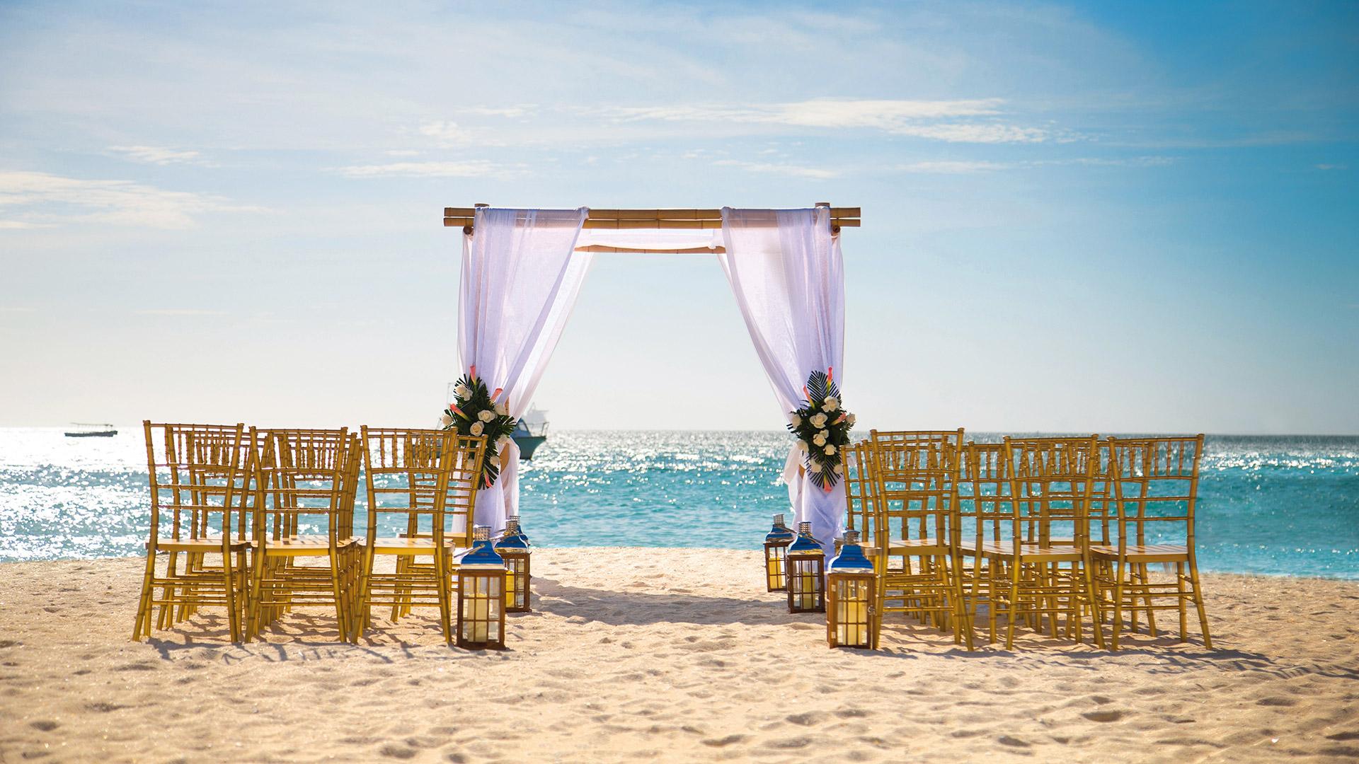 Wedding ceremony setup on the beach during the day