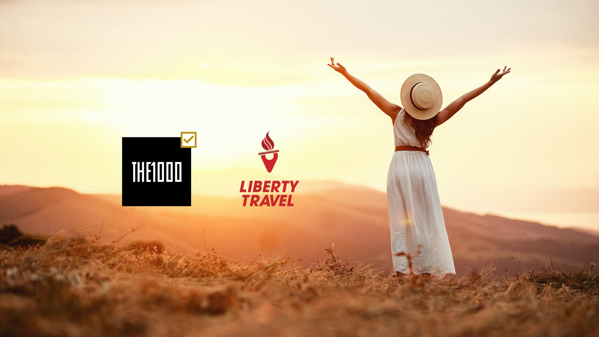 The 1000 Club and Liberty Travel logo over an inspirational travel image of a woman in a field