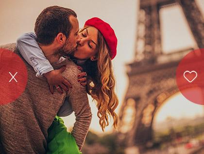 Couple sharing a kiss in front of the Eiffel Tower