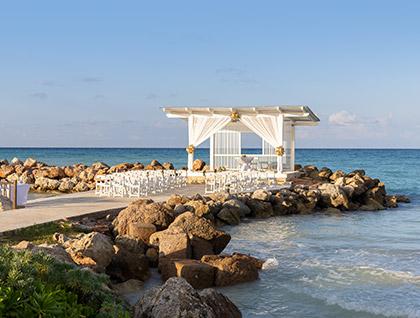 A beautiful wedding ceremony setup on a pier overlooking the ocean at Royalton Blue Waters