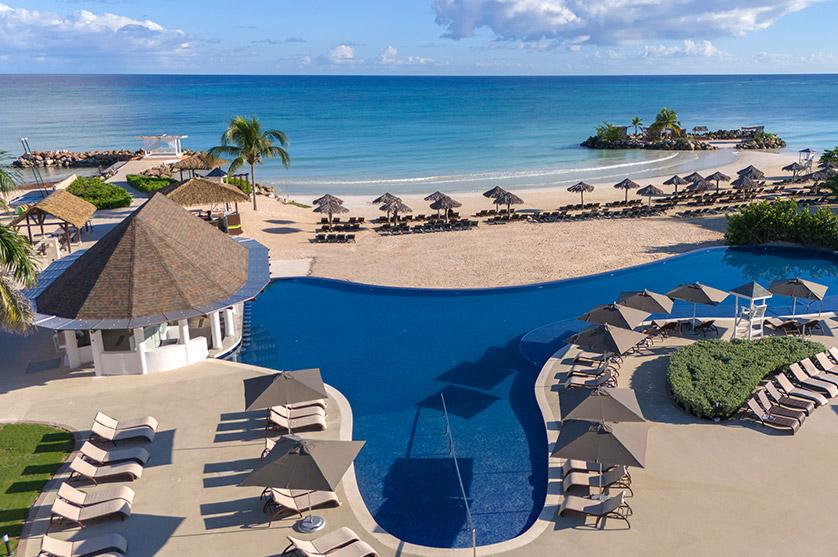 Pool overlooking the beach at Hideaway at Royalton Blue Waters during the day